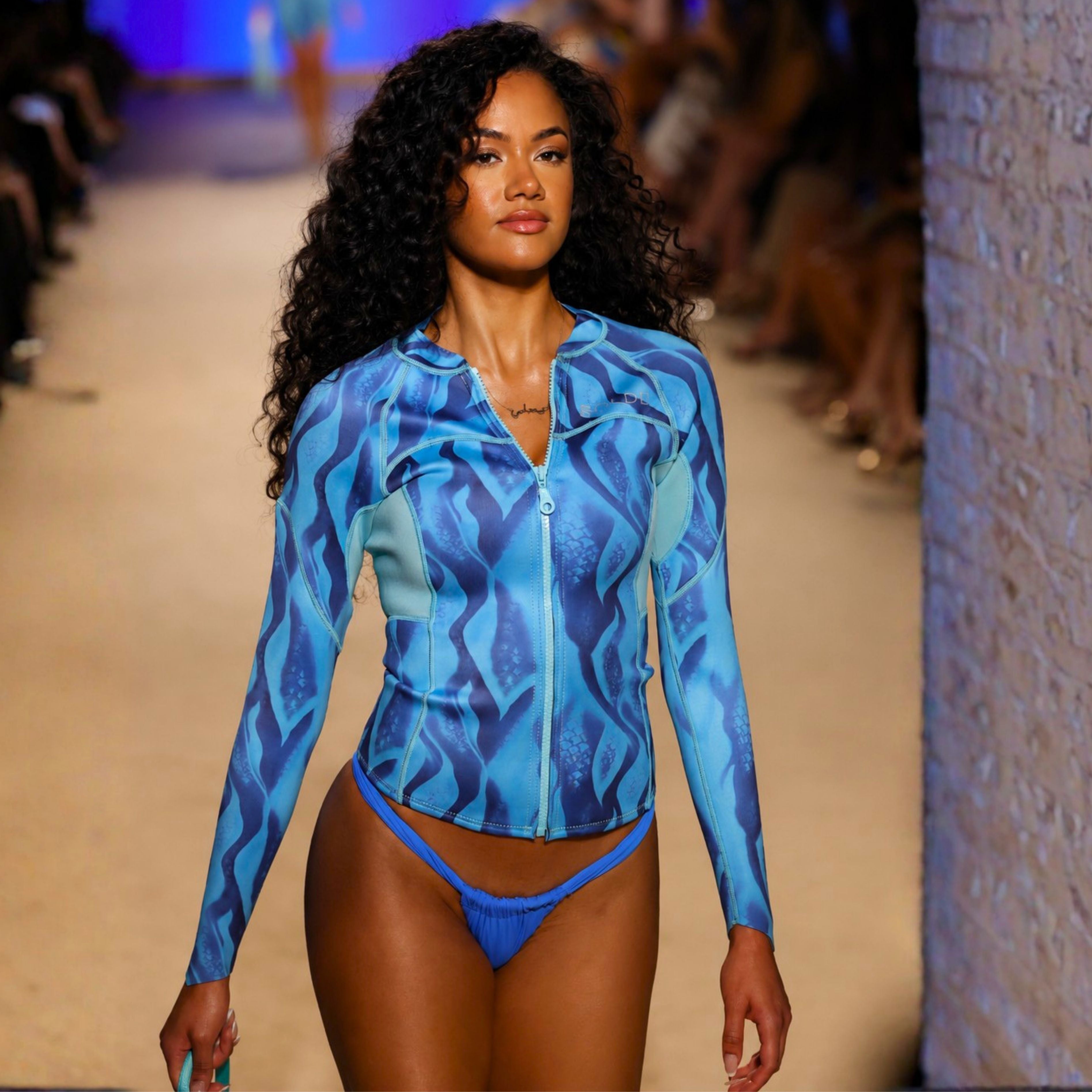 woman wearing blue BOLDE wetsuit jacket at Miami Swim Week